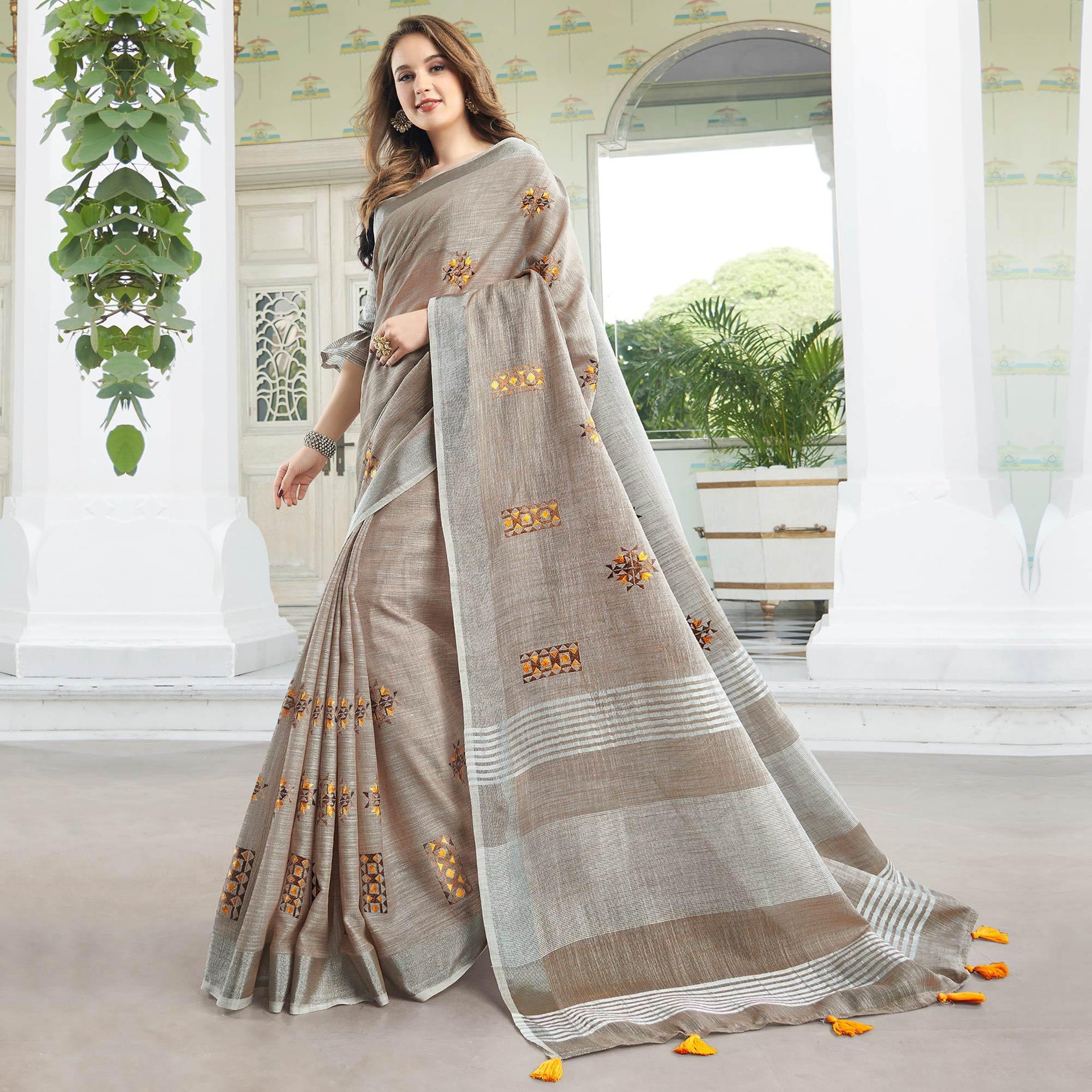 Classy Pastel Brown Colored Casual Wear Floral Embroidered Linen-Cotton Saree With Tassels